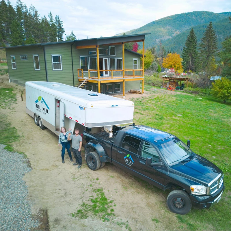 Heather and Tyler Banman owners of Full Deal Insulation standing with truck and trailer.